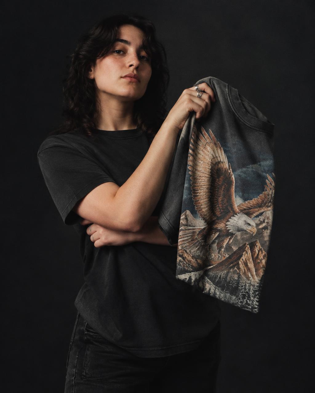 A Shedd seller holding a vintage graphic t-shirt